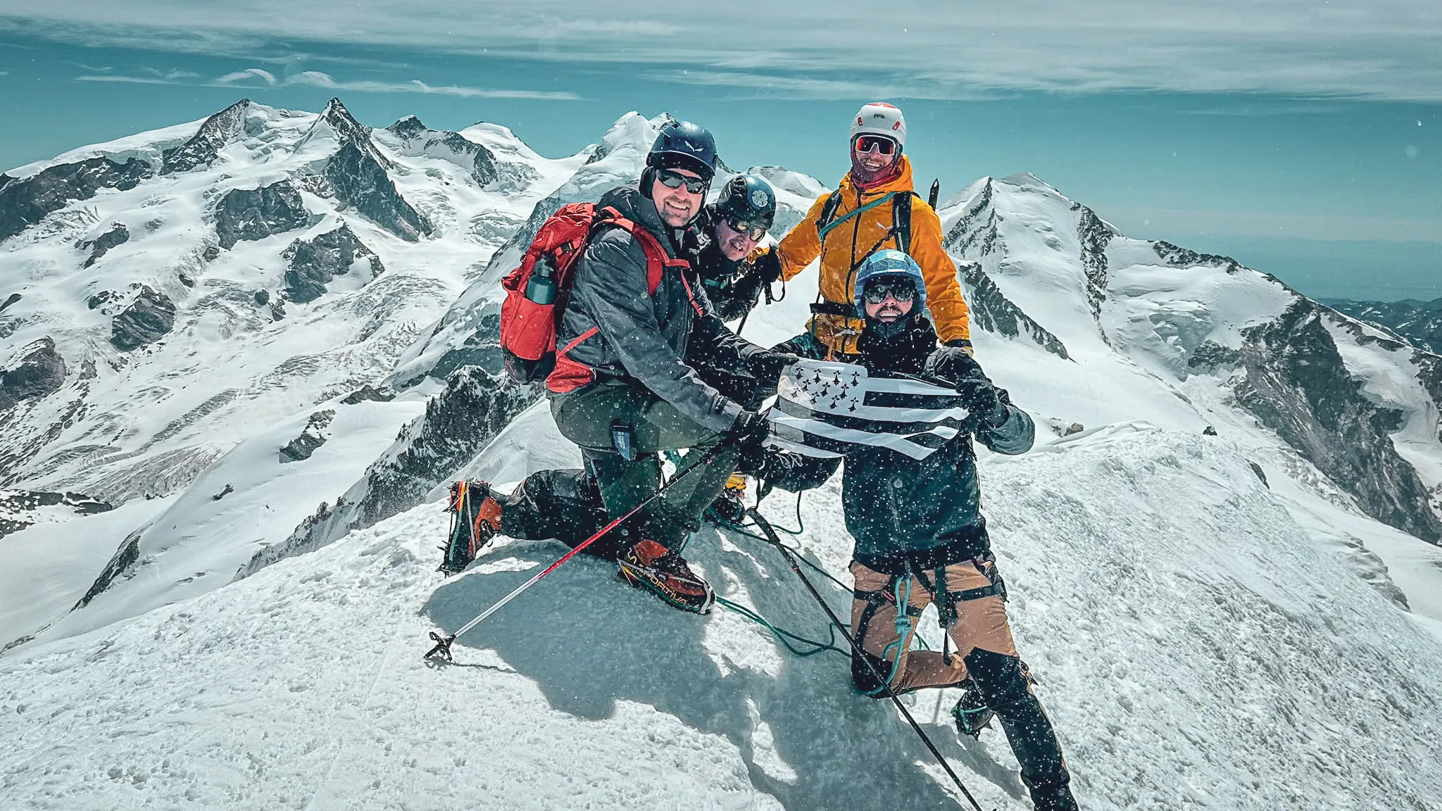 Five smiling climbers at the 4,810m summit of Mont Blanc after the Bosses ridge
