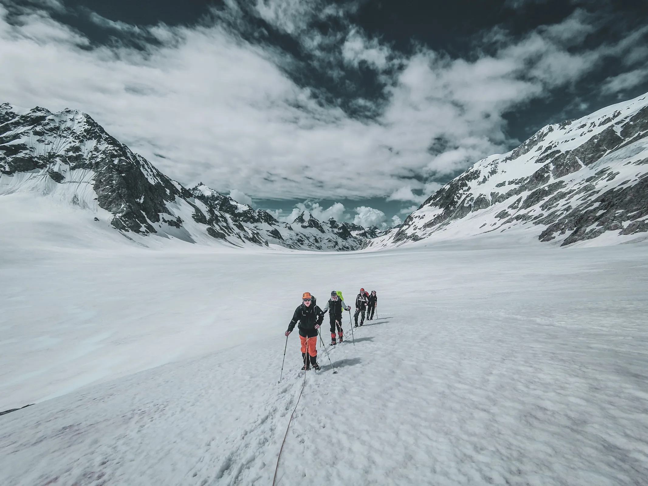 Five roped hikers crossing the Otemma glacier on the Haute Route Chamonix to Zermatt