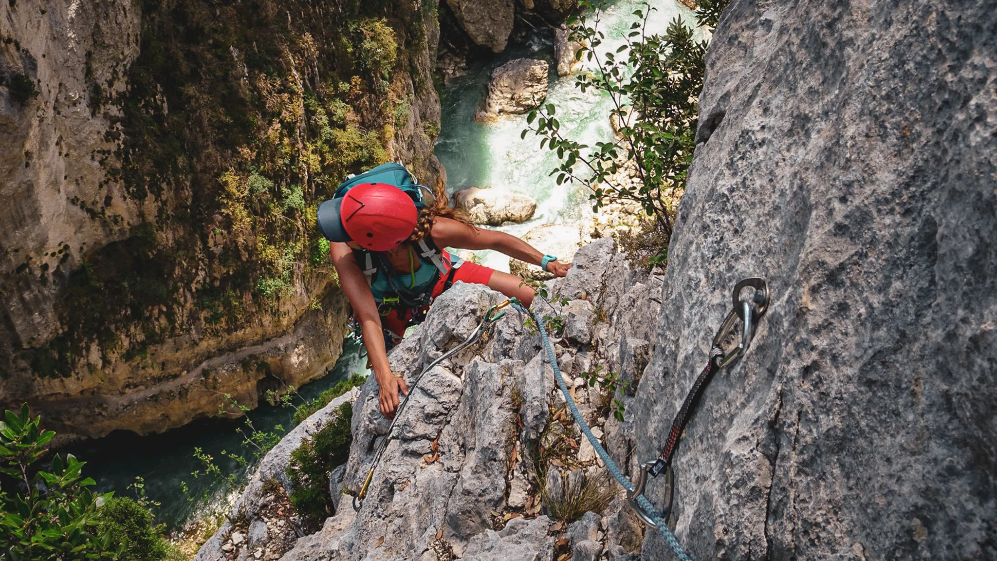 Climbing in the heart of the Gorges du Verdon, beside a sparkling river and under a blue sky.