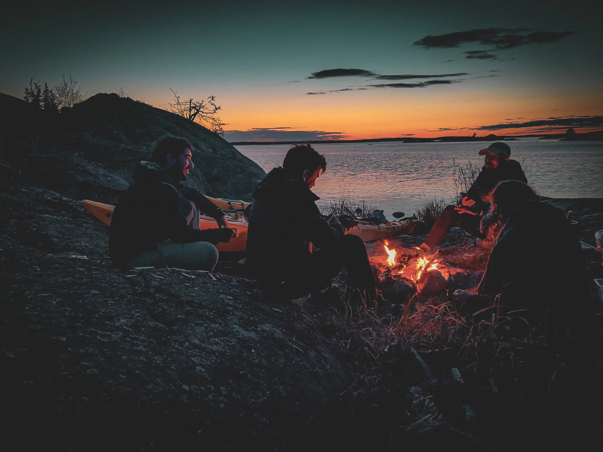 Group bivouacking after a day of sea kayaking, sunset over the Stockholm archipelago.
