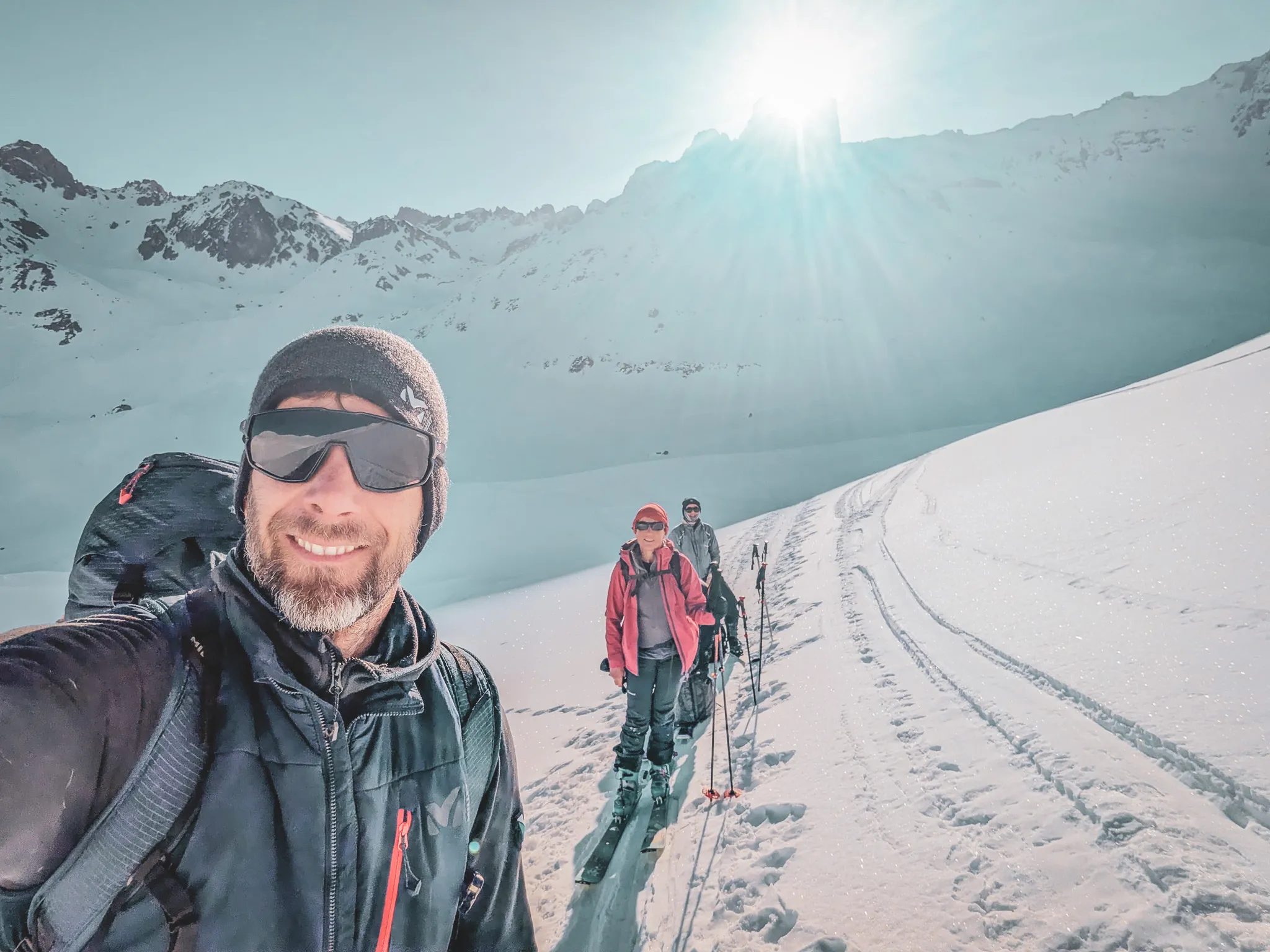 Three ski tourers in the Beaufortain in bright sunshine