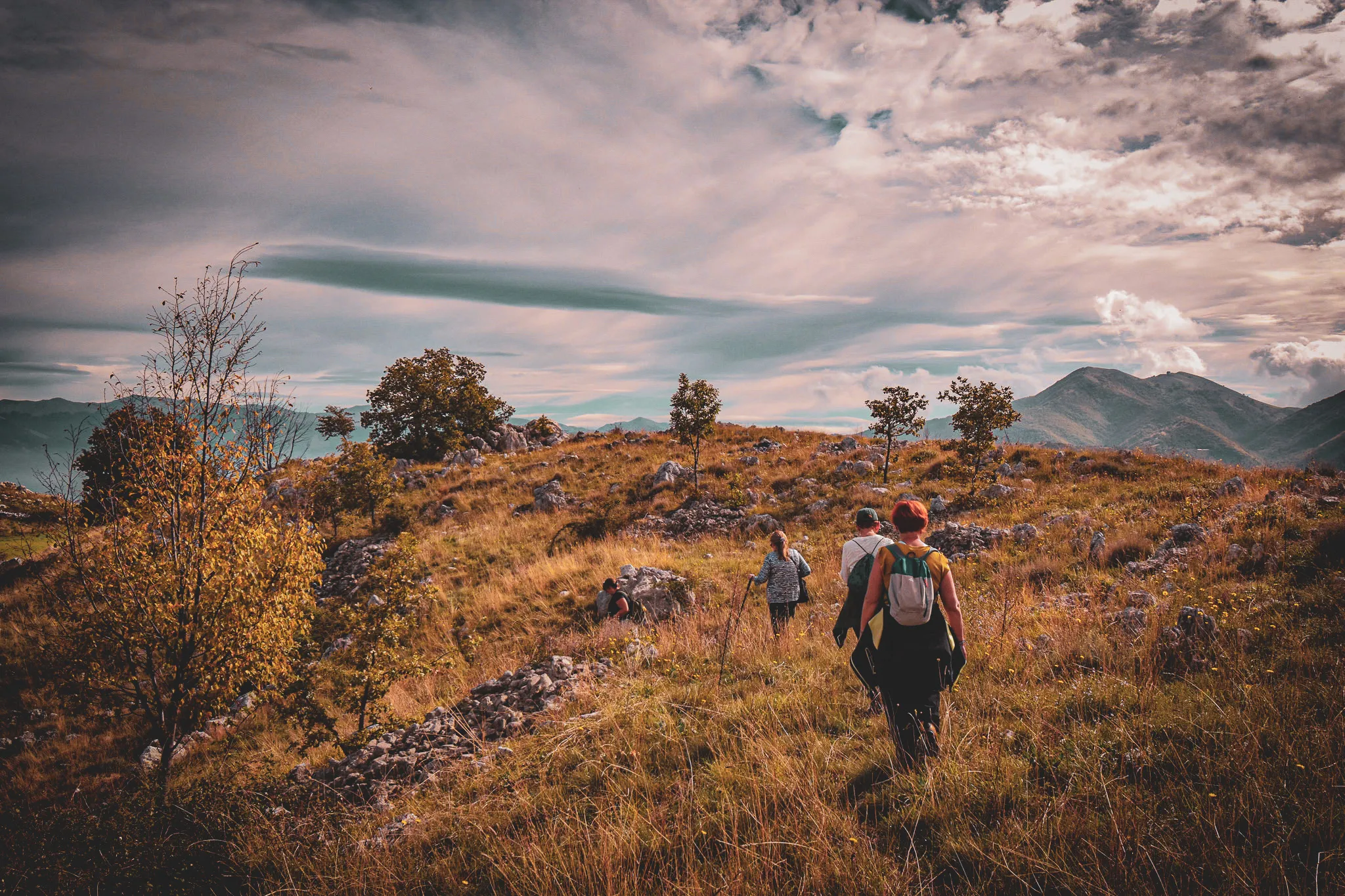 Group of hikers exploring the golden hills of the Valle di Comino in Italy