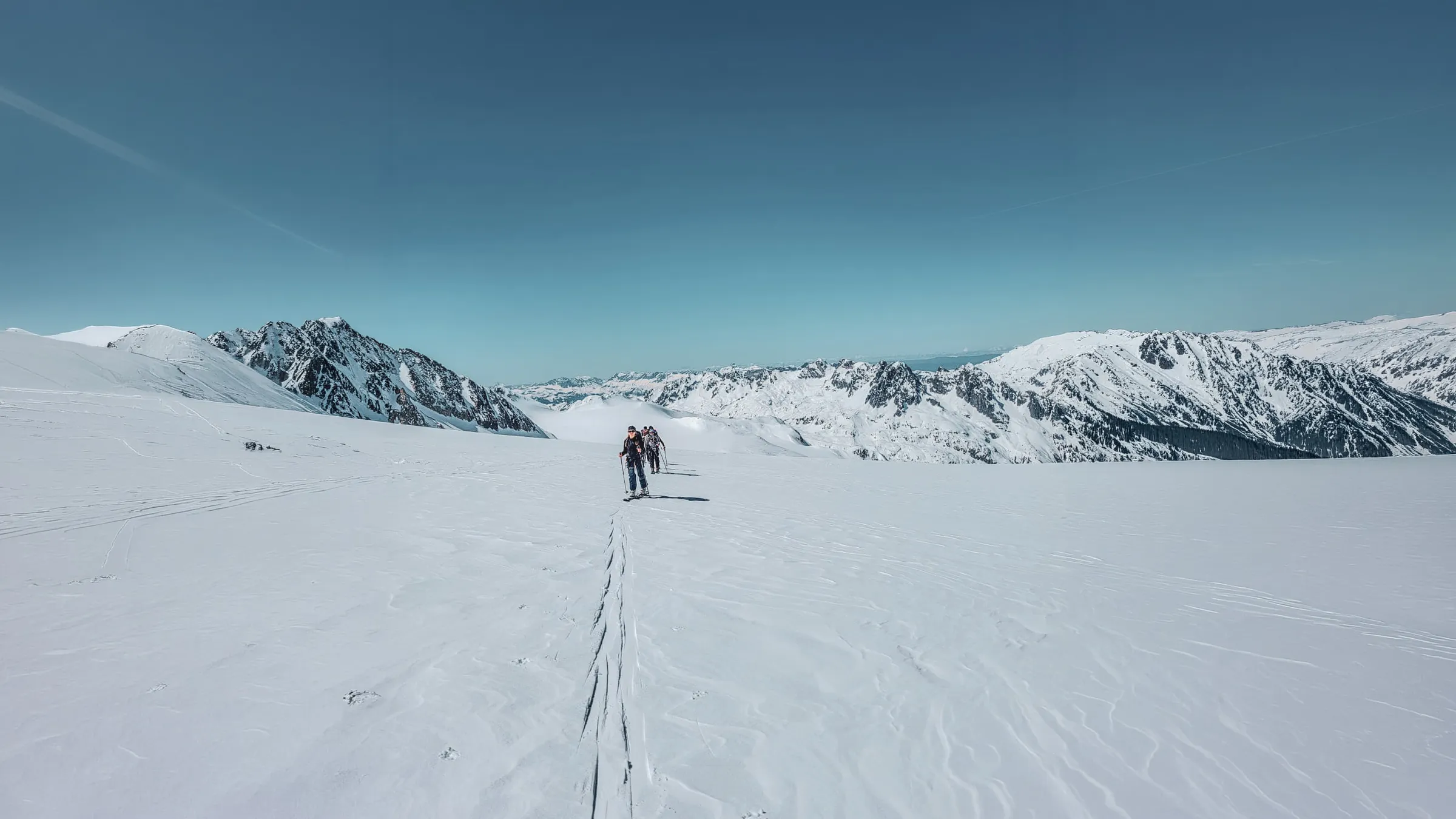 Three skiers on a snowy glacier in the Mont Blanc massif